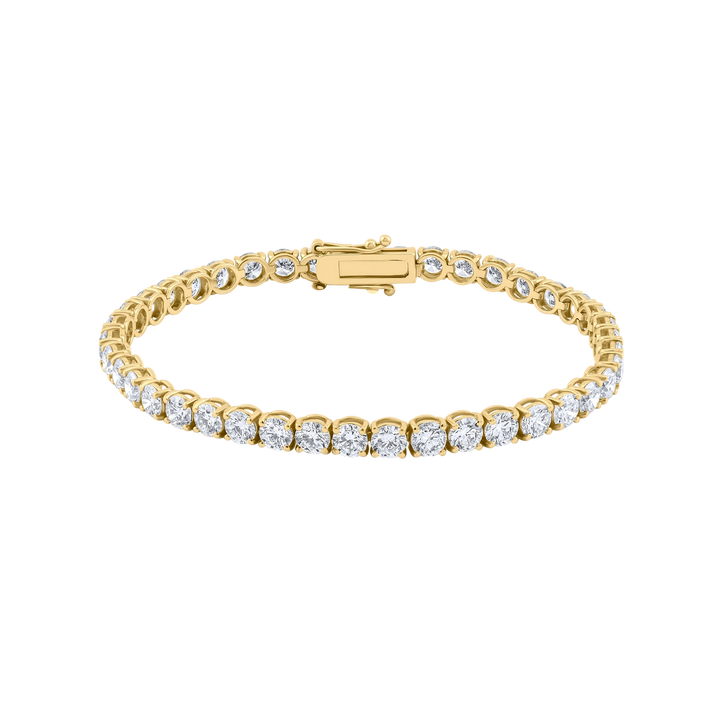 Gold bracelet with clear stones on a white background