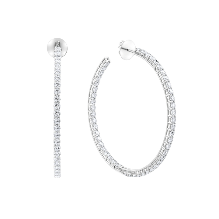 Pair of silver hoop earrings on a white background