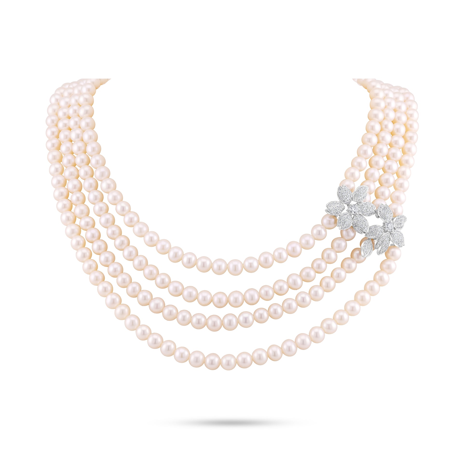 Multi-layered pearl necklace with a diamond flower clasp on a white background