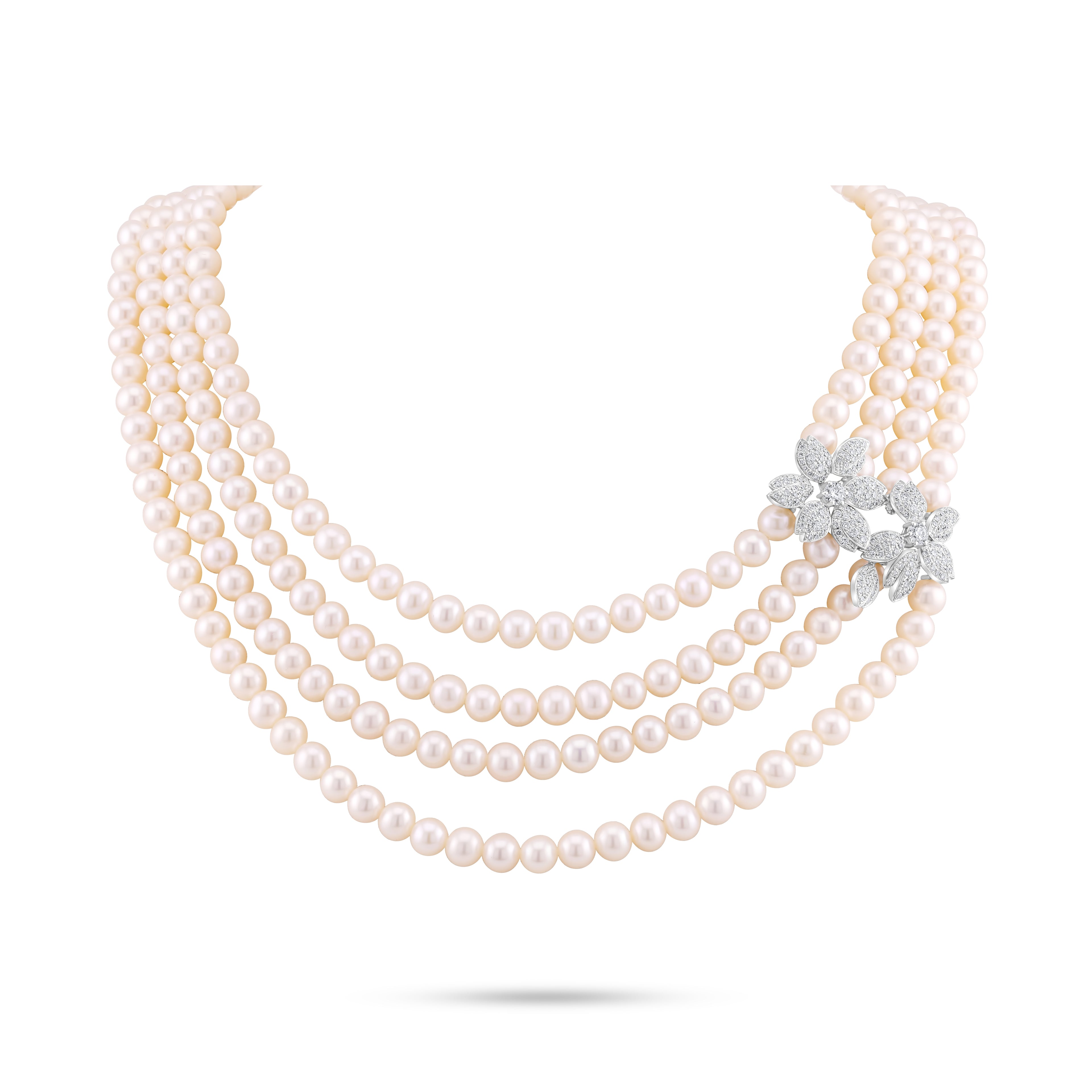 Multi-layered pearl necklace with a diamond flower clasp on a white background