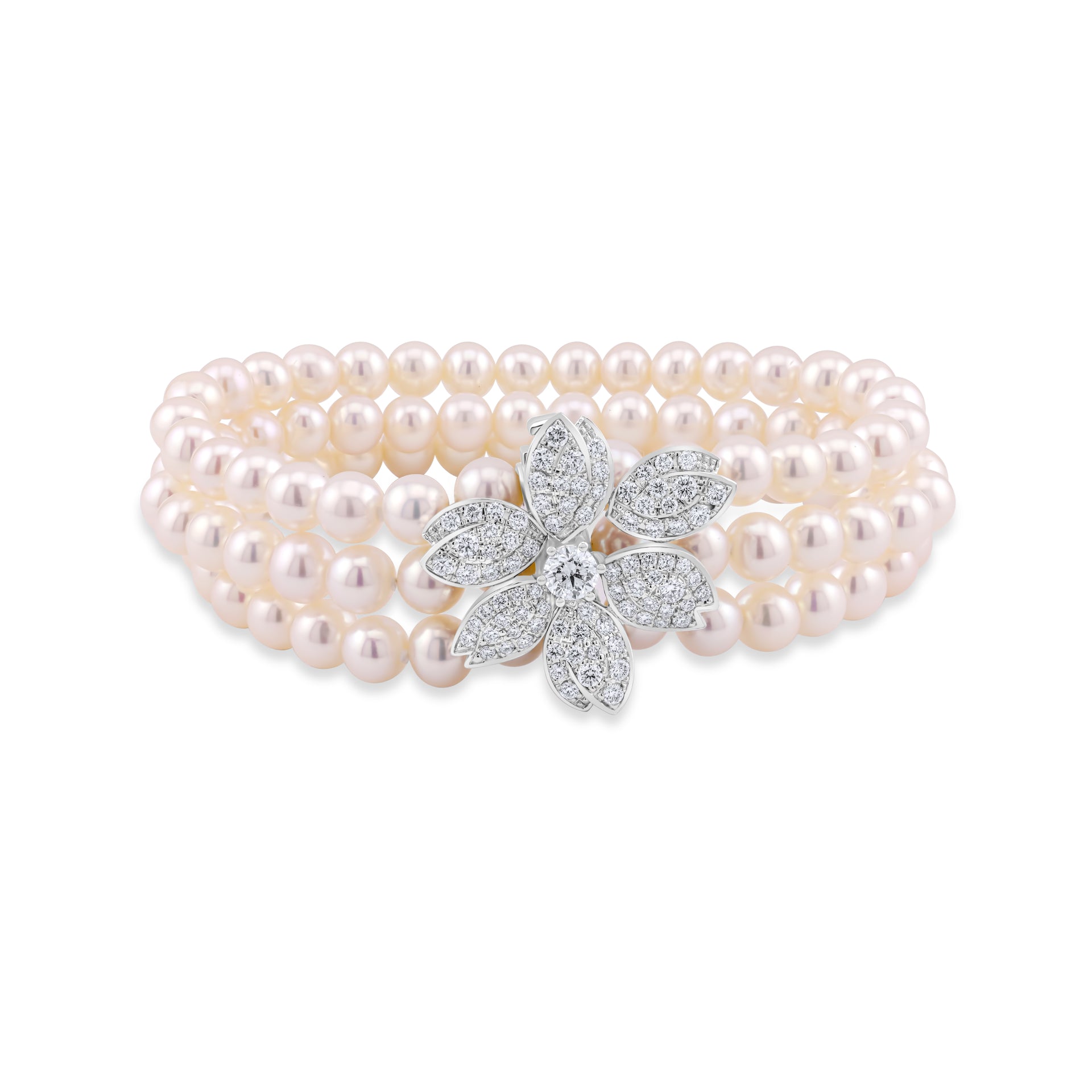 Pearl bracelet with a diamond-encrusted flower clasp on a white background