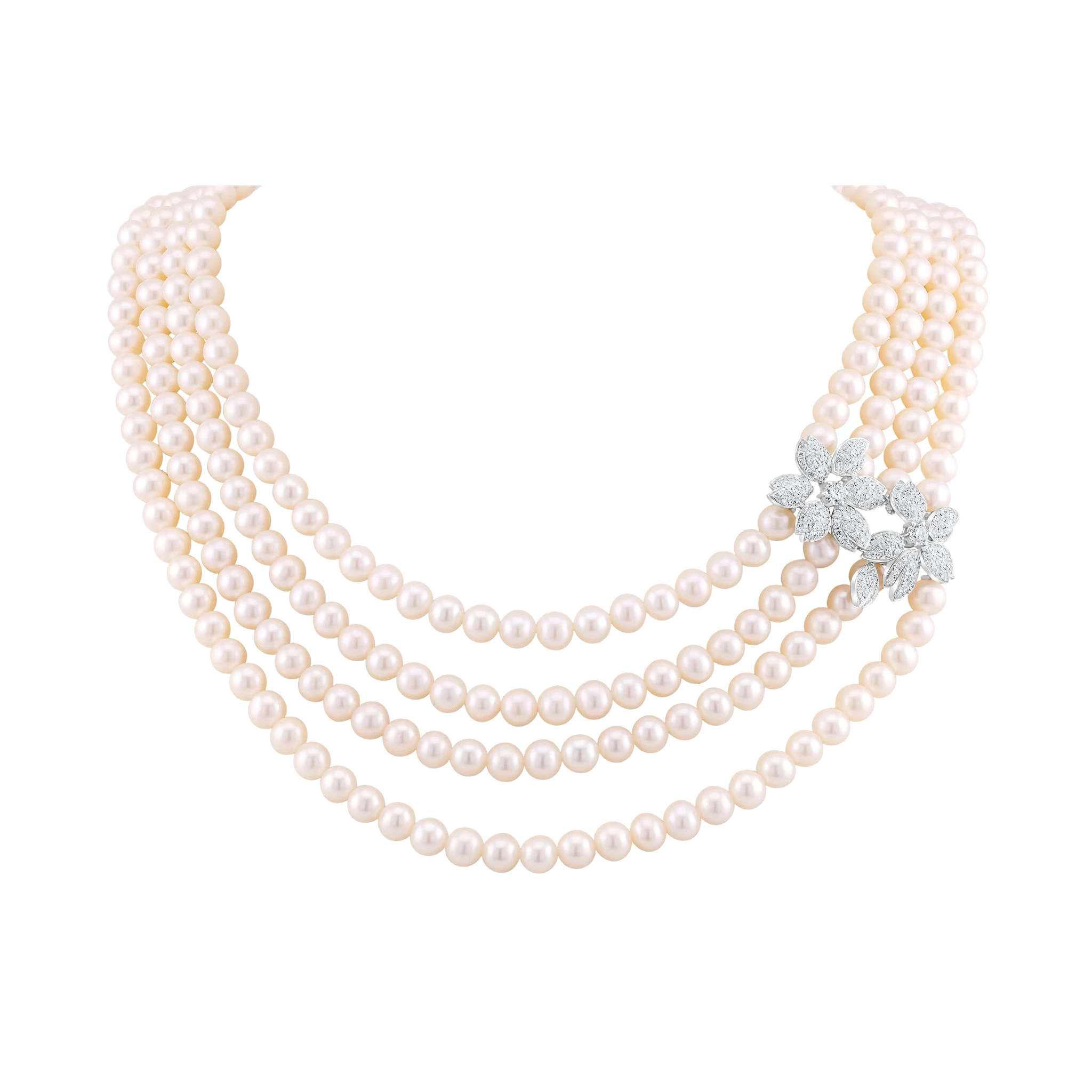 Three-strand pearl necklace with a diamond brooch on a white background