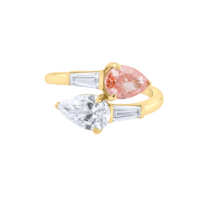 Gold ring with pink and clear gemstones on a white background