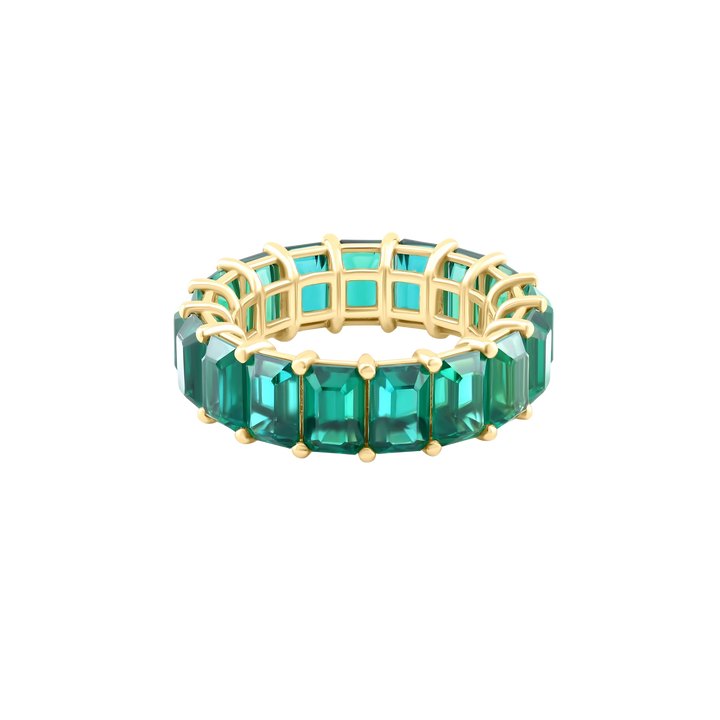 Green gemstone ring with gold band on a white background