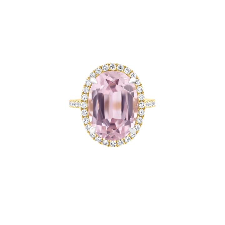 Pink gemstone ring with gold and diamond accents on a white background