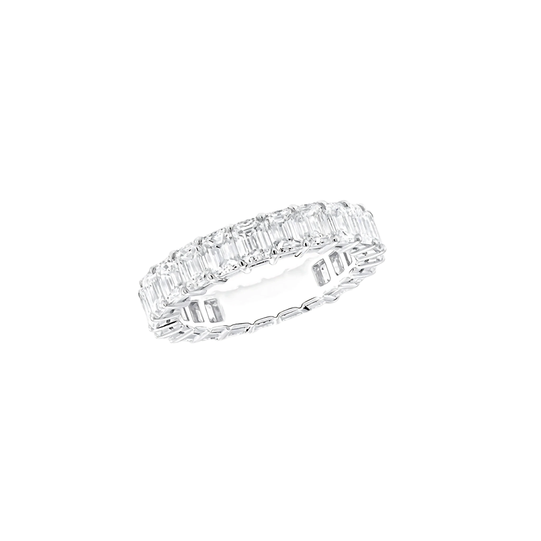 Diamond ring with emerald-cut stones on a white background