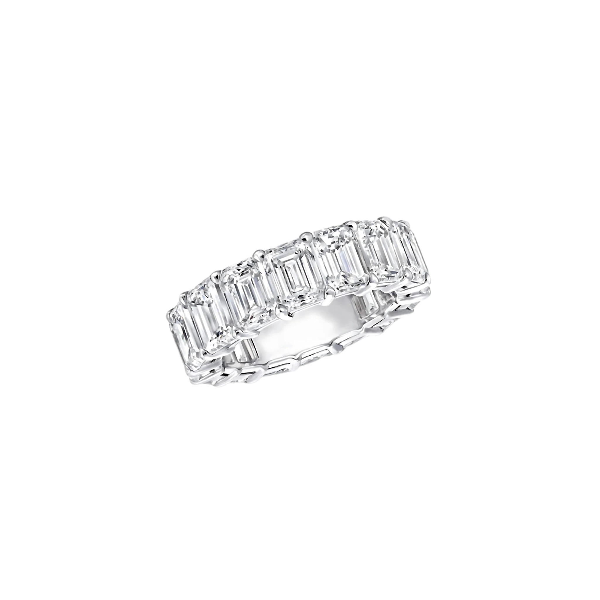 Diamond ring with emerald-cut stones on a white background