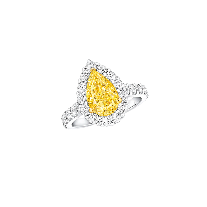 Ring with a yellow pear-shaped diamond and white gemstones on a white background