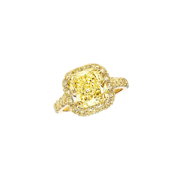 Gold ring with a large yellow gemstone on a white background