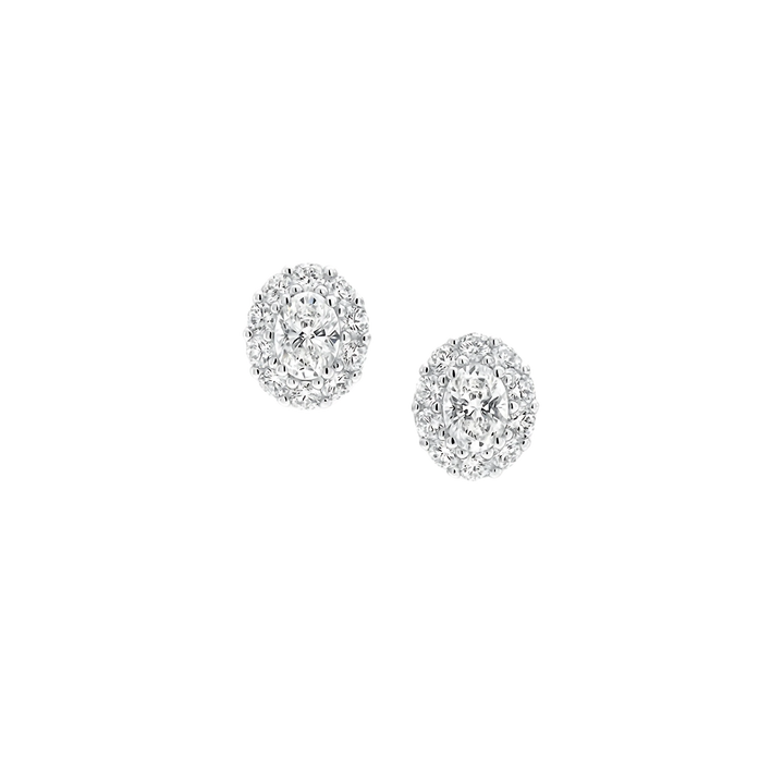 Pair of silver earrings with clear gemstones on a white background