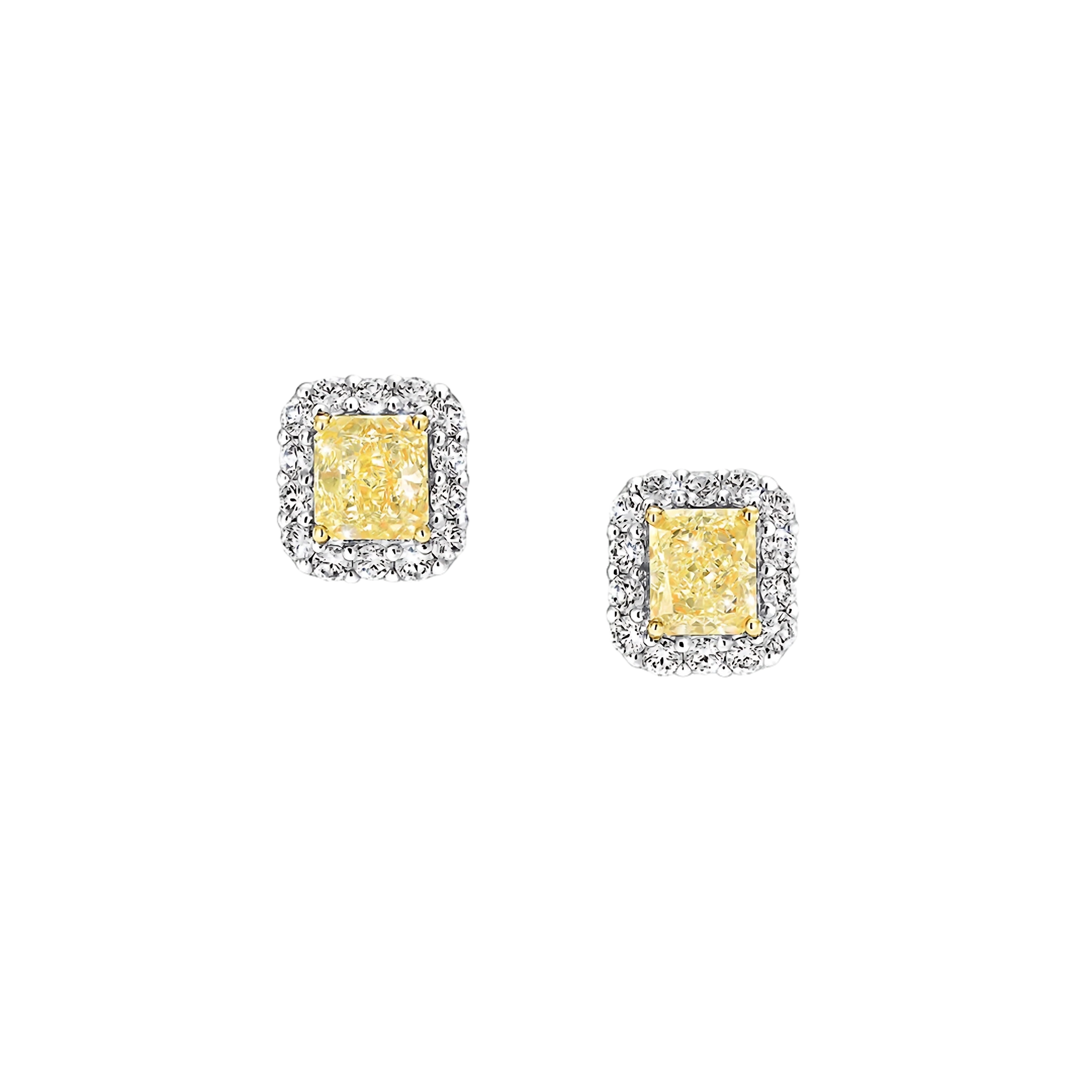Pair of yellow gemstone earrings with silver frames on a white background