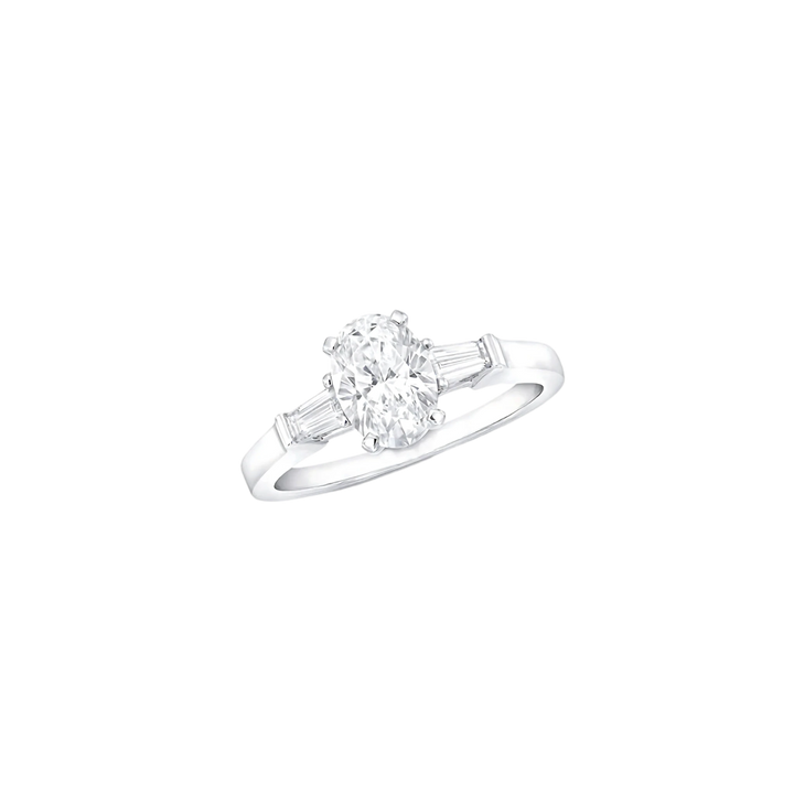 Diamond ring with a central gemstone and two smaller stones on a white background